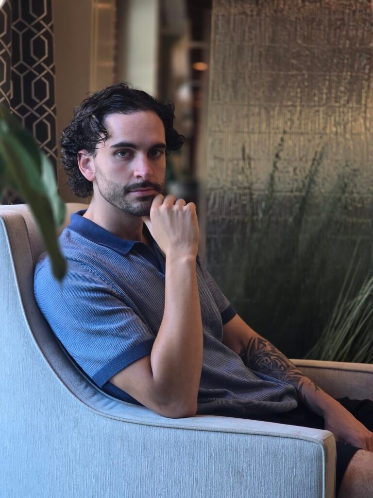 Nick Gallardo, Director of Business Affairs at Neyius Hotel Group, seated in a hotel lounge
