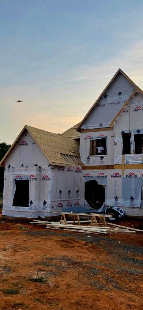 Nick Gallardo filmed by a Neyius Media drone from a window at The Retreat at Highgrove construction site